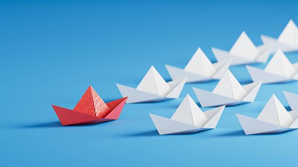 istock Different business concept.new ideas. paper art style. creative idea.Leadership concept with red paper ship leading among white.3D rendering on blue background. 2234406923