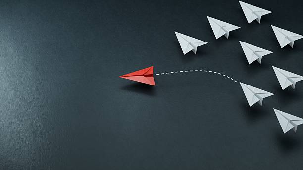 istock Different business concept.new ideas. paper art style. creative idea.red leader plane, standing out from the crowd of white planes.3D rendering on black background. 2234406942