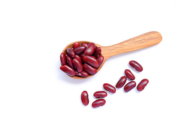 istock Red kidney beans in spoon on white background 2234407491
