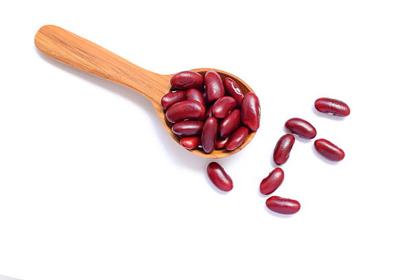 istock Red kidney beans in spoon on white background 2234407492