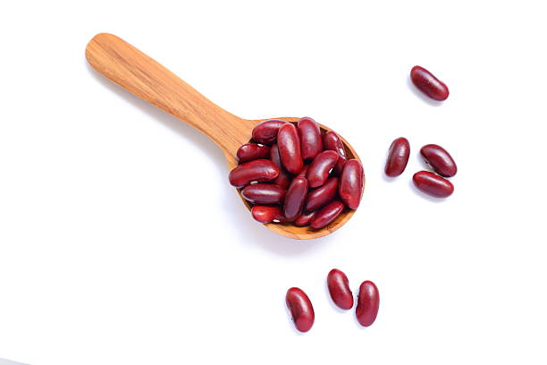 istock Red kidney beans in spoon on white background 2234407504
