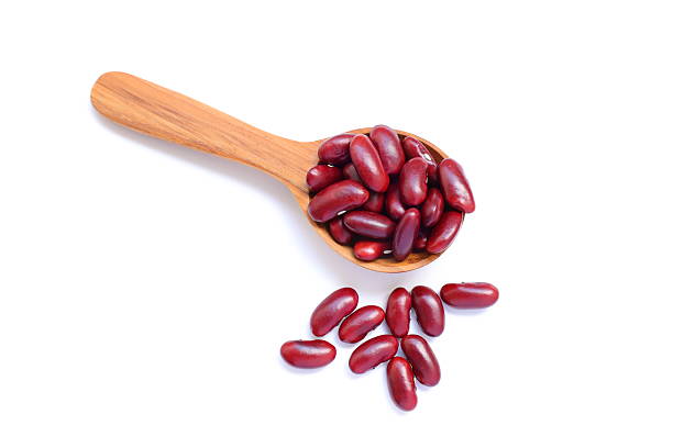 istock Red kidney beans in spoon on white background 2234407506
