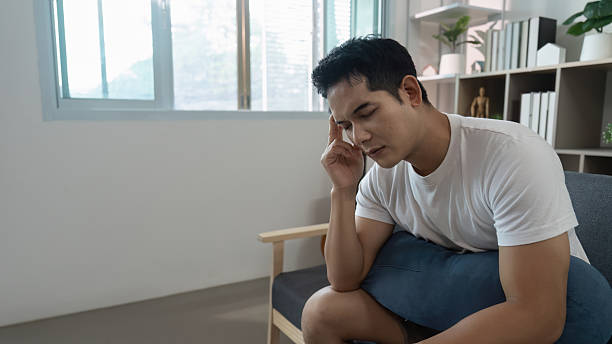 istock Coping with stress. Young man reflecting on his feelings at home. 2234408867