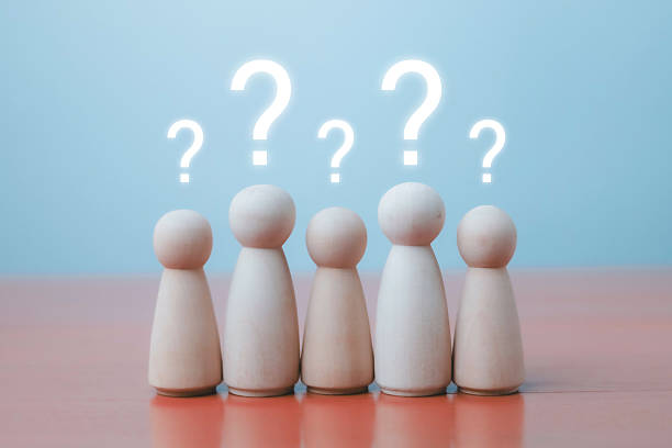 istock Wooden human figures with glowing question marks above their heads, symbolizing confusion, brainstorming, problem solving, FAQ, teamwork, and decision making in business or education concepts. 2234409101