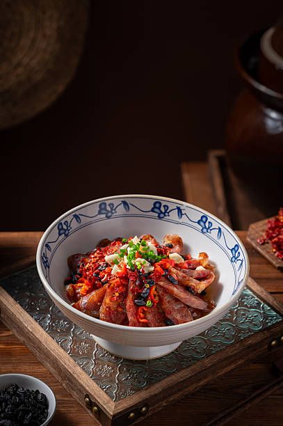 Chinese sausage slices and peppers, vintage kitchen interior wooden tabletop background