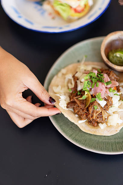 istock Close-Up of a Taco Dish with Assorted Condiments and Iced Coffee 2234411611