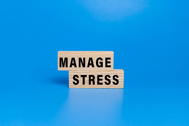 istock manage stress words text on wooden blocks isolated on blue background 2234415952