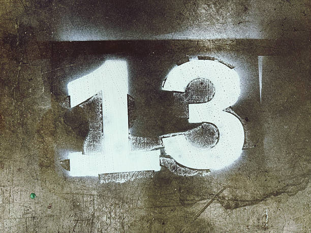 istock Number 13 painted in white on an old concrete wall, grunge background 2234417211