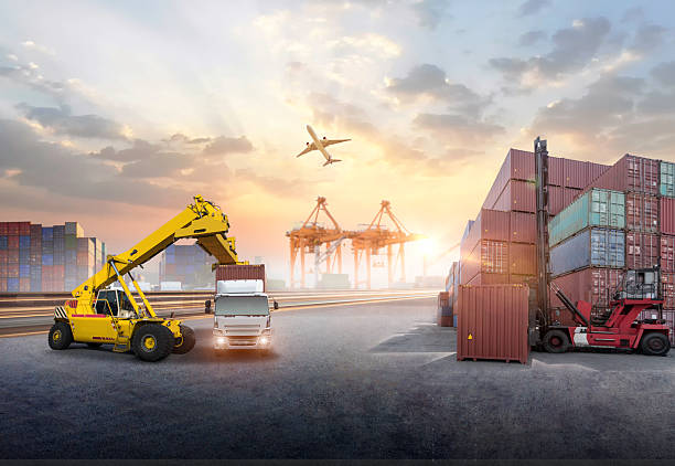 istock forklift handling container box loading to truck in import export logistic, Business logistics concept 2234421214