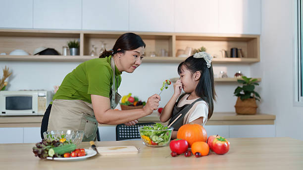 istock Healthy Eating. Mother teaching daughter about fresh vegetables in modern kitchen. 2234423948