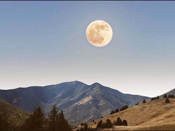 Nature of the moon above the mountain.