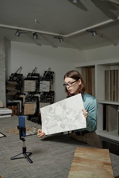 istock Young Caucasian Woman Presenting Marble Tile Sample during Online Video Call 2234428419