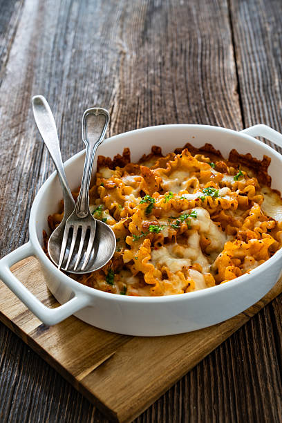 istock Noodle casserole with ground pork , mozzarella cheese and vegetables on wooden table 2234428762