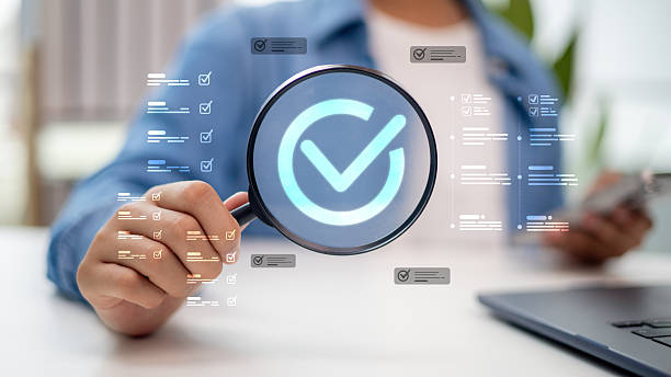 istock Businessman holding magnifying glass with digital checklist, approval mark, and task verification concept for quality control, project management, and compliance audit. 2234431314
