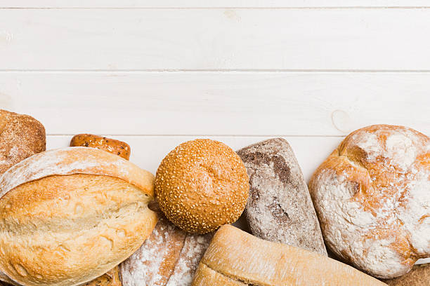 istock Homemade natural breads. Different kinds of fresh bread as background, top view with copy space 2234433995