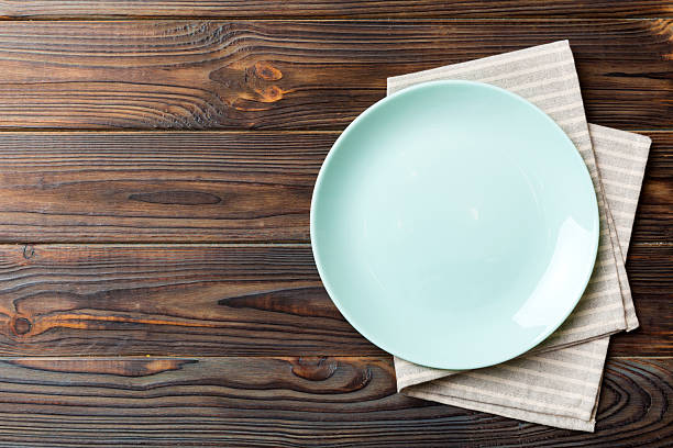 istock Top view on colored background empty round blue plate on tablecloth for food. Empty dish on napkin with space for your design 2234434060