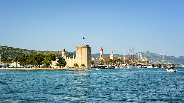 Beautiful old buildings, boats and yachts on the promenade in Trogir, Croatia. Sunny summer day in Trogir.
