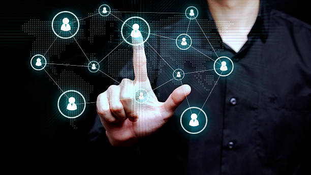 istock A business professional touches a digital interface with connected user icons over a world map to illustrate recruitment and global collaboration. 2234436263