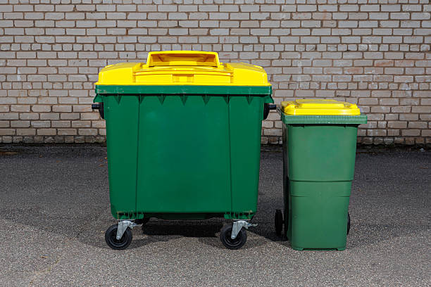 istock Large and Small Green Recycling Bins with Yellow Lids 2234436704