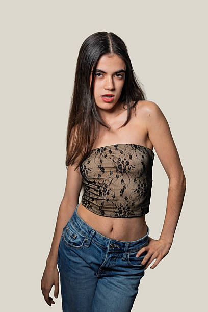 istock Young woman posing with hand on hip and biting lip 2234437812