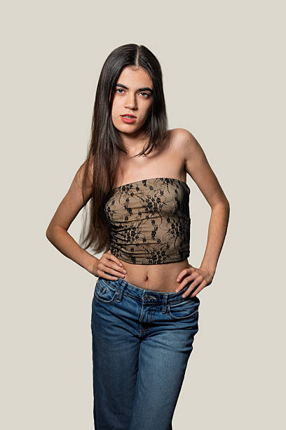istock Young woman posing with hands on hips in studio setting 2234437831