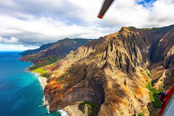 The beautiful skyline of Honolulu, Hawaii on the island of Oahu shot via helicopter from over the ocean from an altitude of about 600 feet.