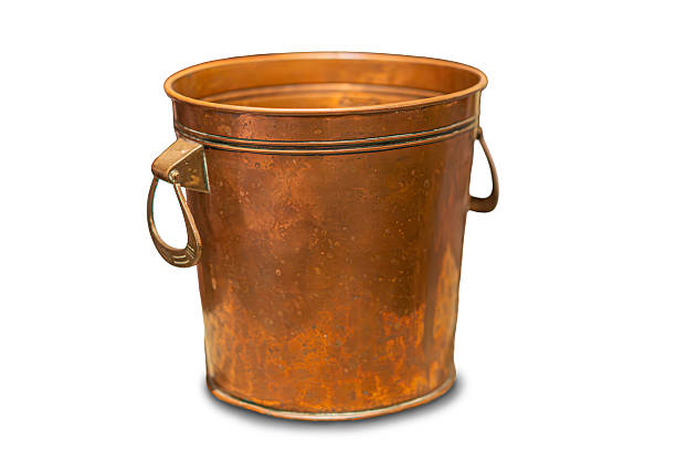 Well worn watering can in agricultural barn.