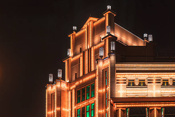 Modern building at night with Christmas decor, illuminated by warm lights a