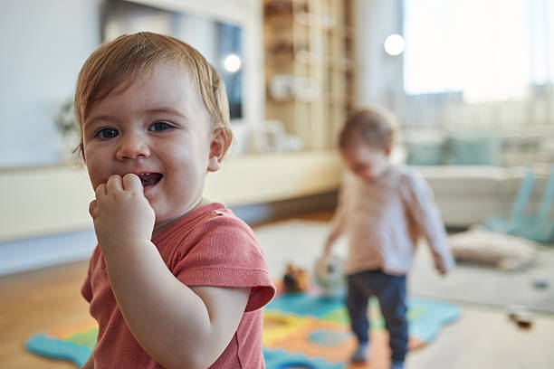 istock Twin baby sisters playing indoors 2234446767