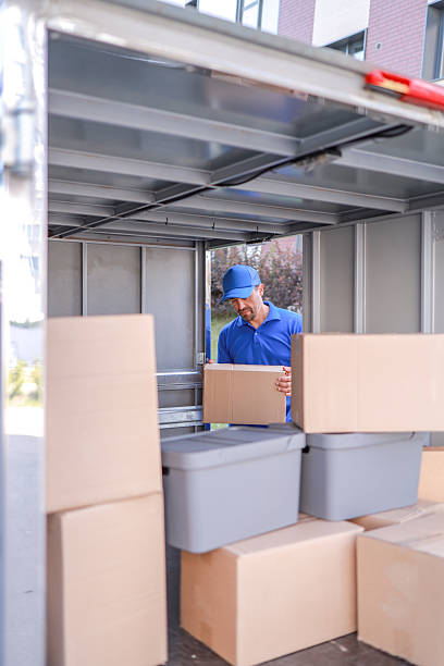 istock Close-up courier service employee unloading goods from a van for delivery to customers. concept logistics, delivery services 2234449482