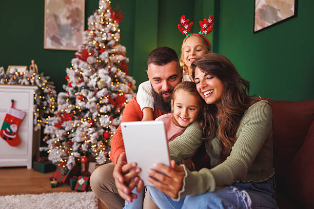 istock Family having fun taking selfies by the Christmas tree 2234451639