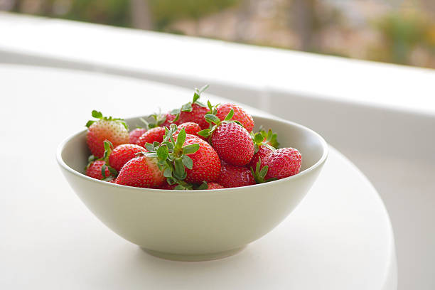 Fresh Strawberries in a Bowl on White Table.