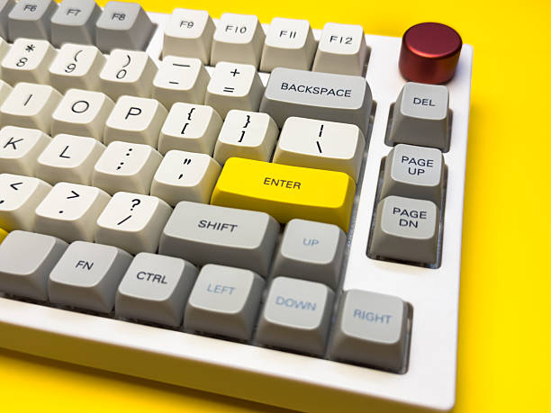 istock White mechanical keyboard with bright Enter key on bright yellow background, minimalism, keyboard buttons. A keyboard with a yellow key on the bottom left 2234453937