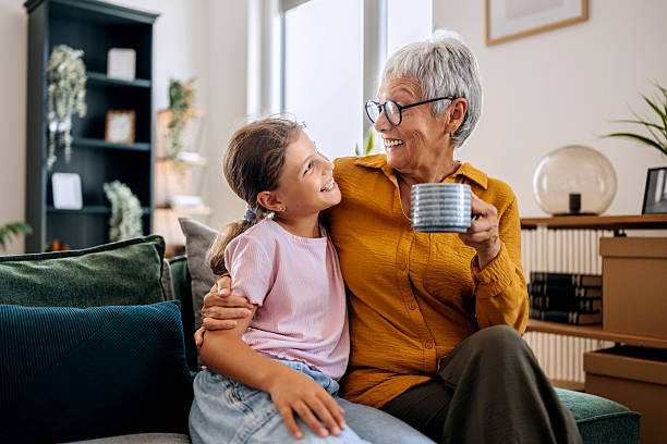 istock Grandmother and granddaughter bonding on sofa 2234457849