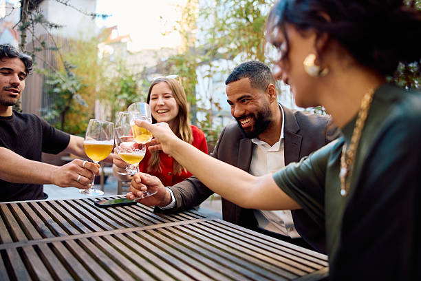 istock Happy business colleagues toasting with drinks at outdoor terrace table, celebrating teamwork and success 2234457855