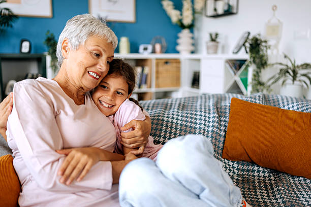 istock Grandmother and granddaughter bonding on sofa 2234457867
