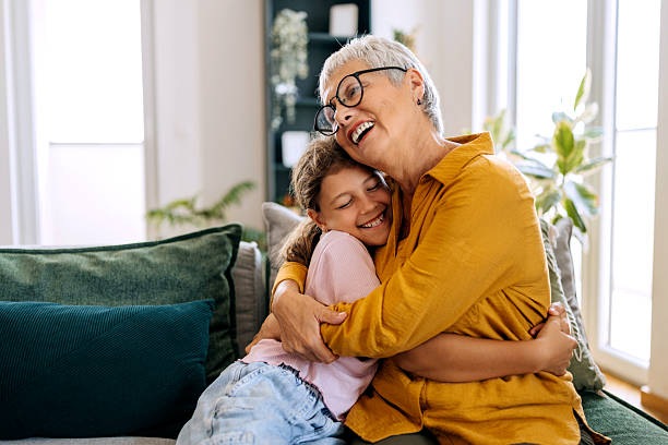istock Grandmother and granddaughter bonding on sofa 2234458367