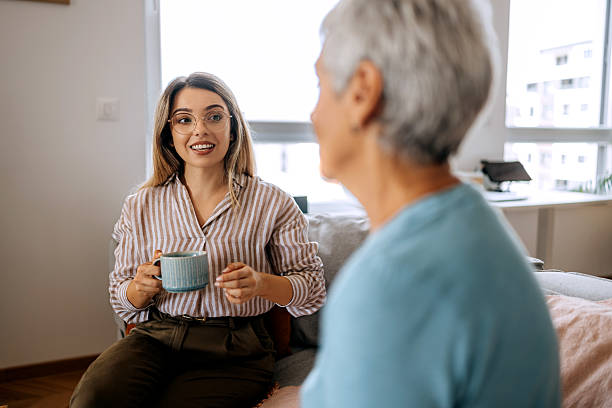 istock Senior woman having coffee and bonding with her daughter 2234458449