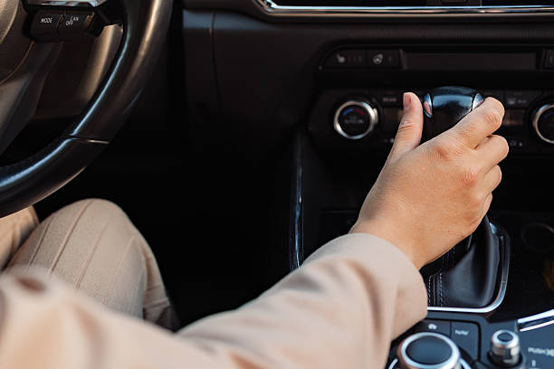 istock A close-up of a person's hand on a car's automatic gear shift. 2234459302