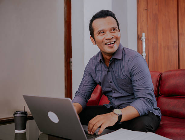 istock Cheerful asian businessman using laptop in the office. 2234459504