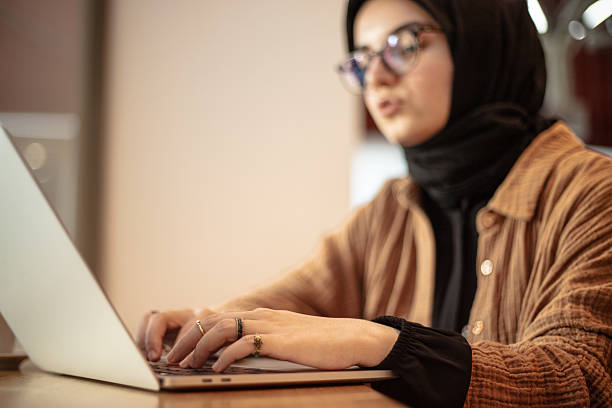 istock Young hijab woman is working remotely on the outside. 2234461061