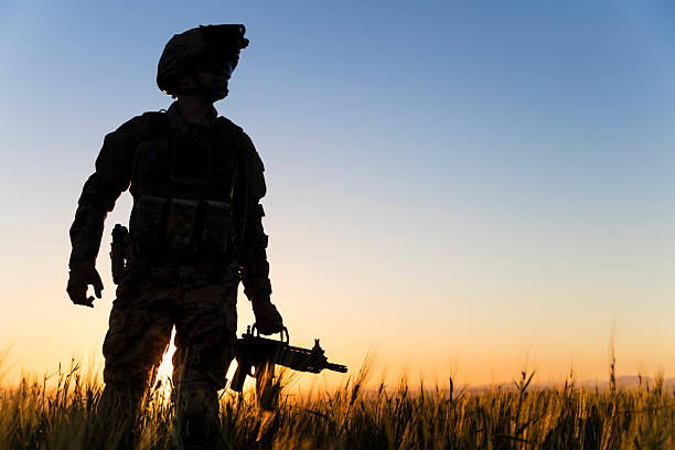 istock Soldier walking in battlefield at sunset 2234462025
