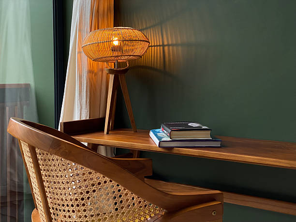 istock Table lamp with rattan shade on wooden table 2234462326