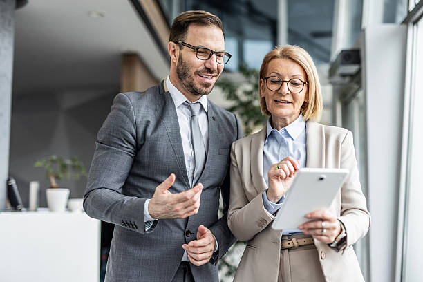 istock Businesspeople collaborating on digital tablet in modern office 2234464277