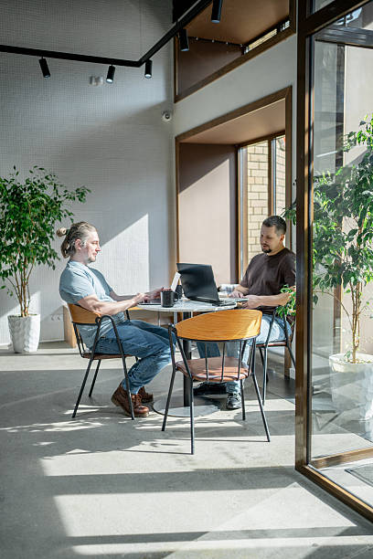 istock Two It Software engineers working on project and programming in coffee shop. Business people concept. 2234464300
