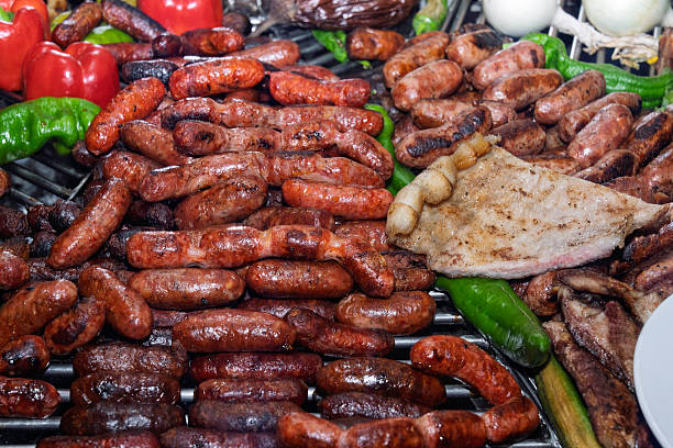 istock Grilled sausages and meat with vegetables on barbecue. 2234464383