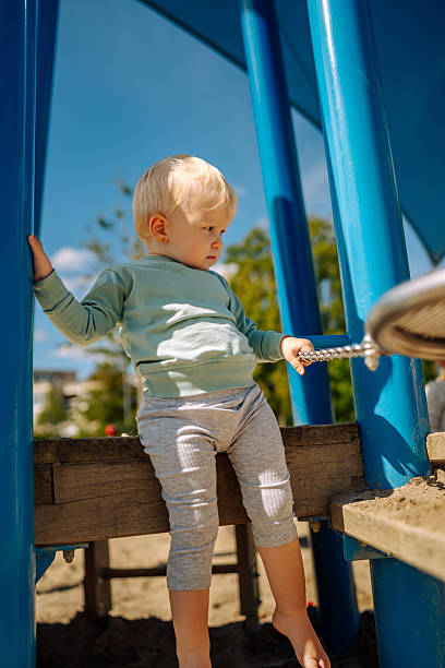 istock Toddler balancing on playground platform 2234466787