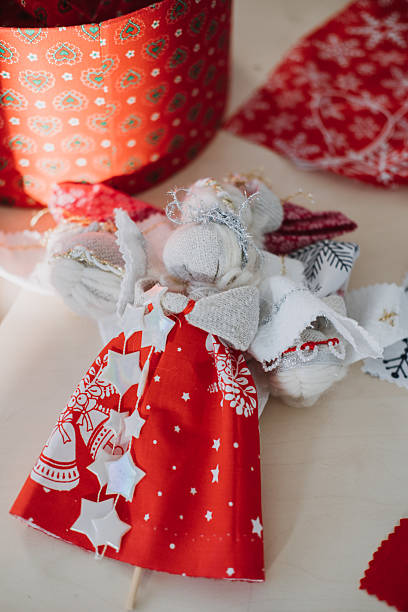 istock Handmade angel doll with red and white patterned fabric. Symbolizing cultural traditions, heirloom craftsmanship, and meaningful holiday gifting. 2234467237