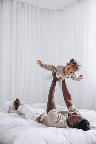 istock Father playing and lifting his baby daughter up. 2234467509