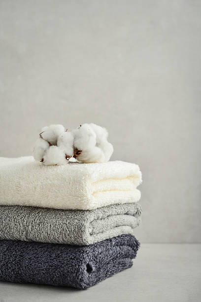 istock Stack of bath towels with cotton flowers 2234468246
